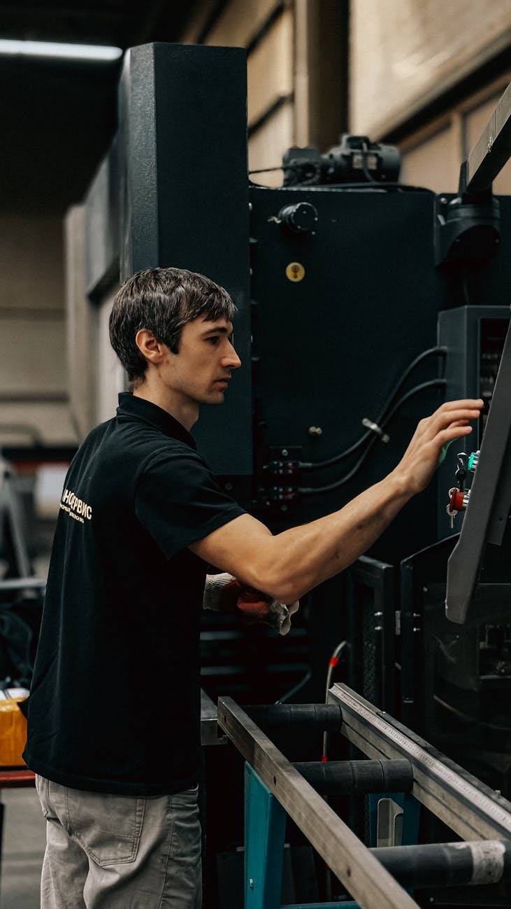industrial worker operating machinery indoors