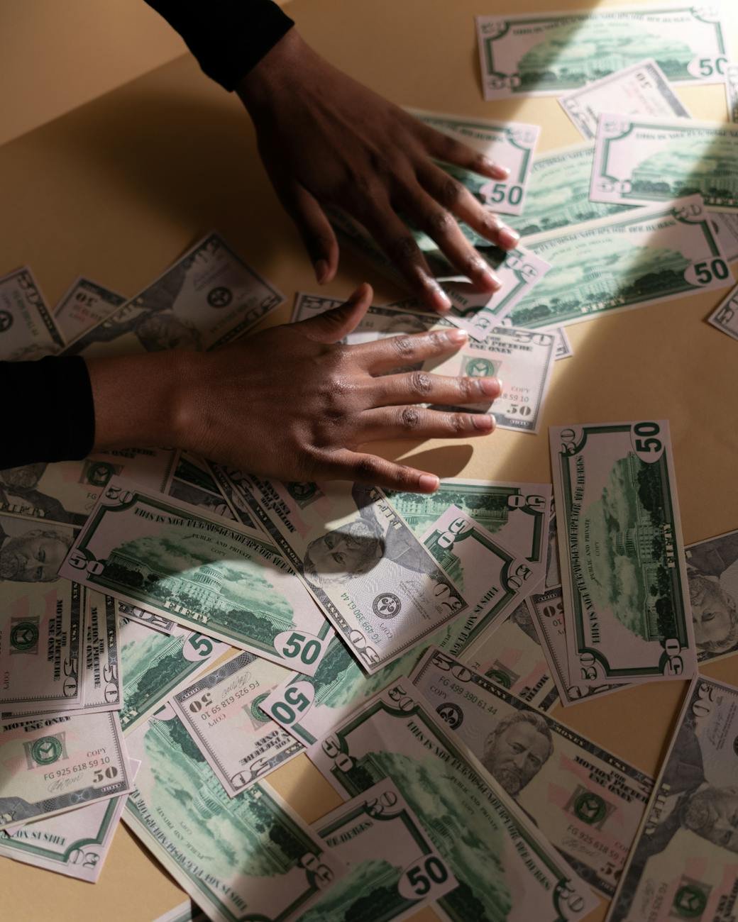 person spreading money on the table